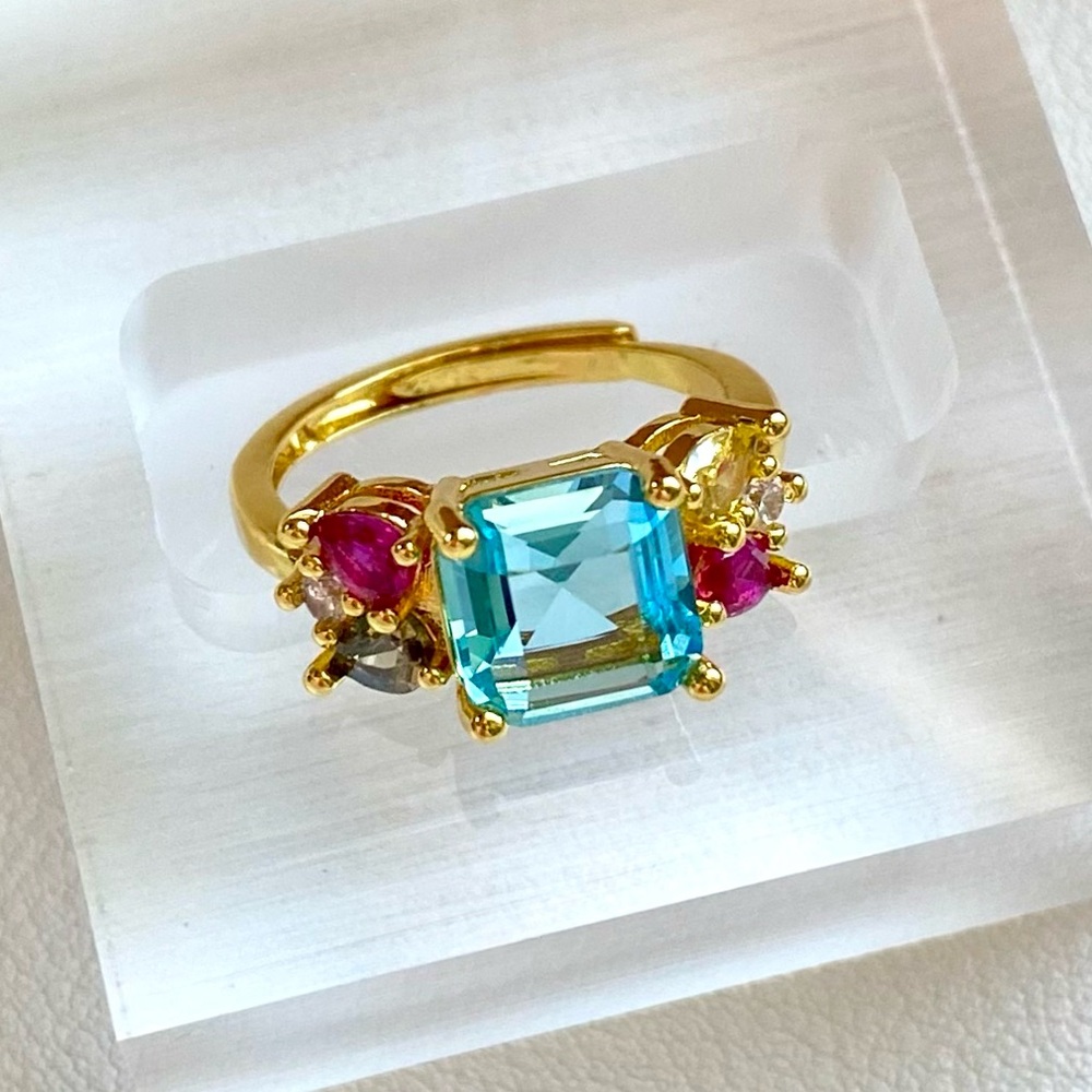 Gold Ring with Blue Center Stone and Multi-Gem Accents